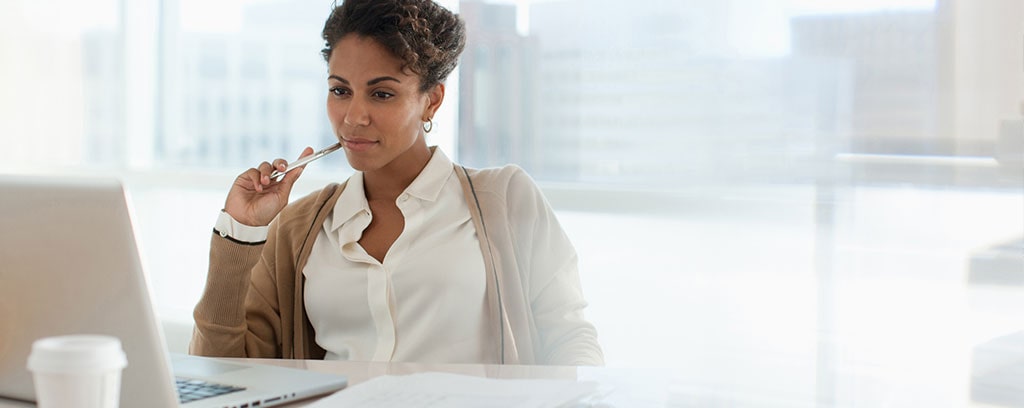 A woman works at a laptop