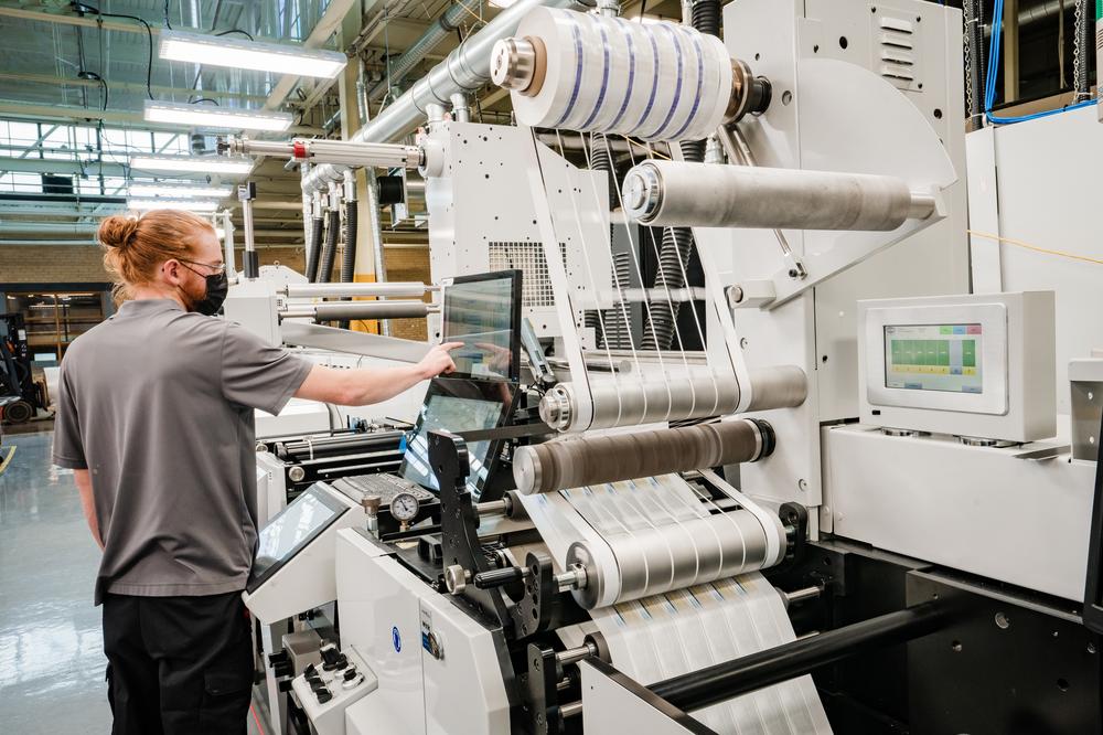 Man working on Hyrbrid printer at A1 Labels