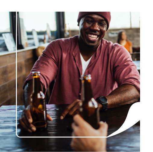 Man holding a custom label beer bottle at a bar