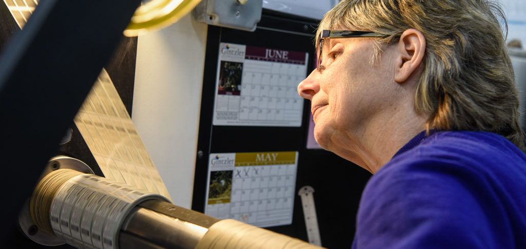 Woman checking in on printing press