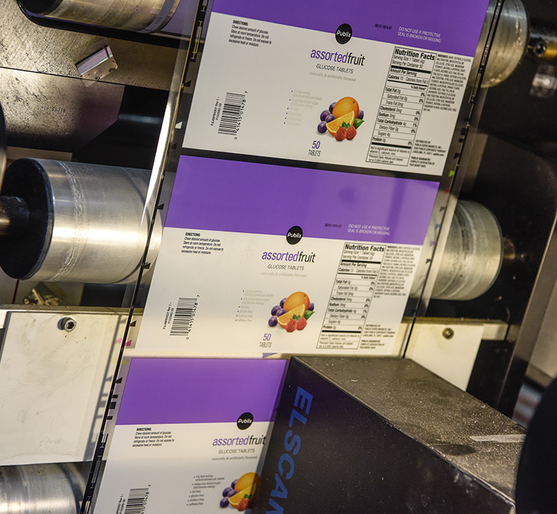Vitamin custom labels running through printing press