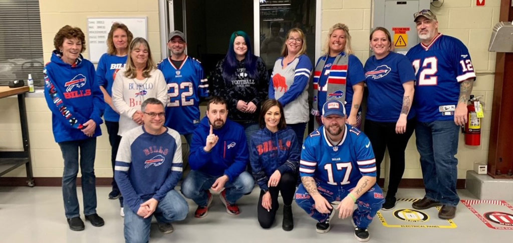Gintzler staff dressed in blue and jerseys to celebrate Bill's Day