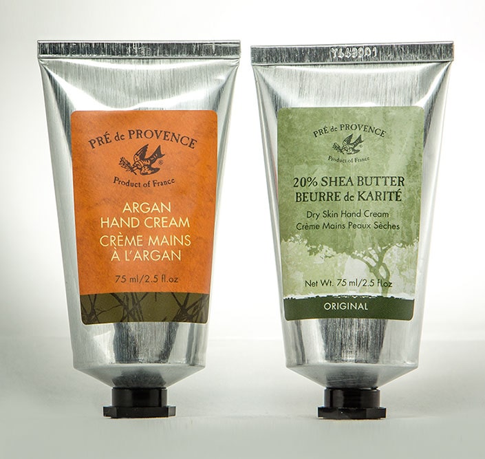 Two aluminum squeeze tubes of hand cream with custom labels