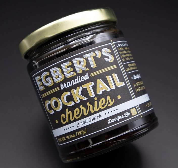 Egbet's Brandied Cocktail Cherries in a n angled jar with custom label 