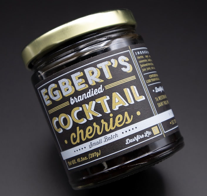 Egbet's Brandied Cocktail Cherries in a n angled jar with custom label