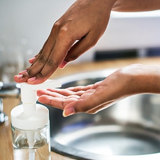 A woman washes her hands