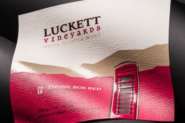 Wine label using selective varnish to create contrast on textured paper