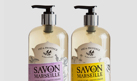 Two liquid soap bottles with custom die cut labels