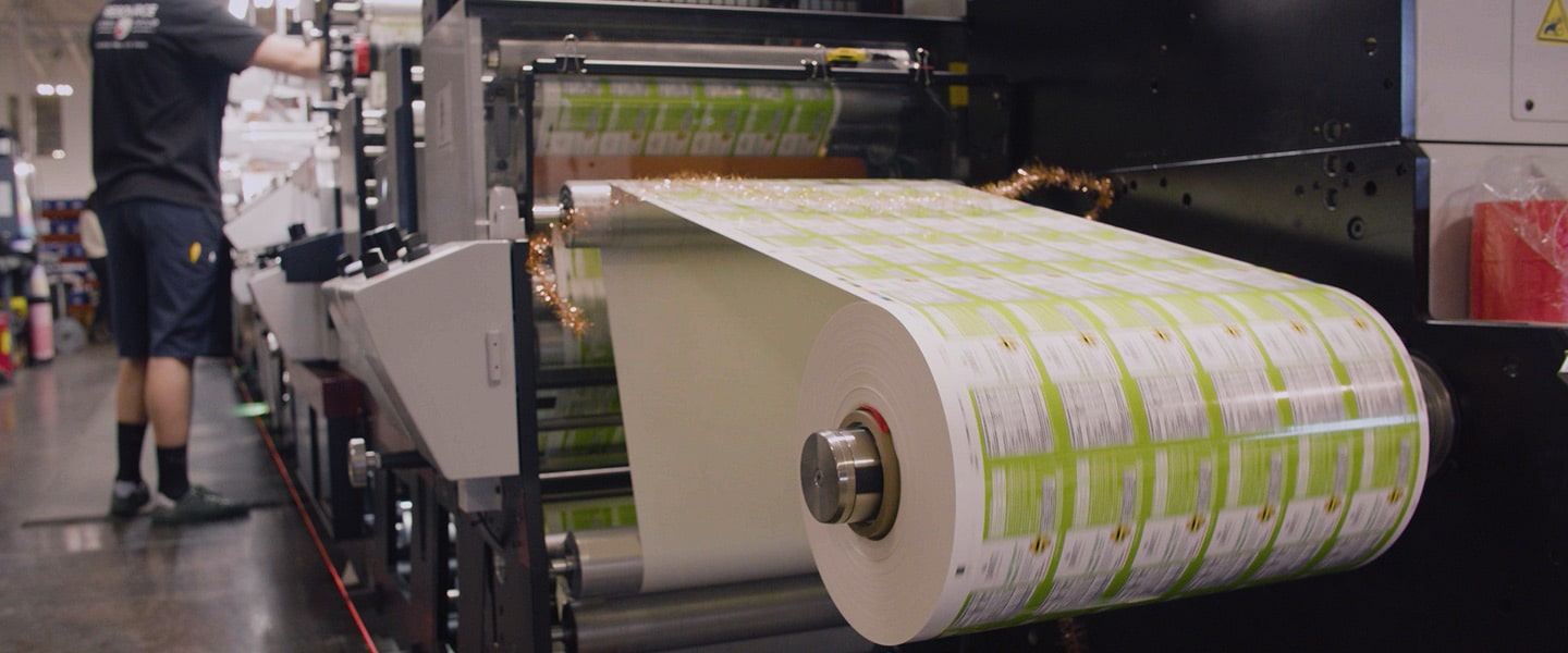 Press operator producing printed labels on a press