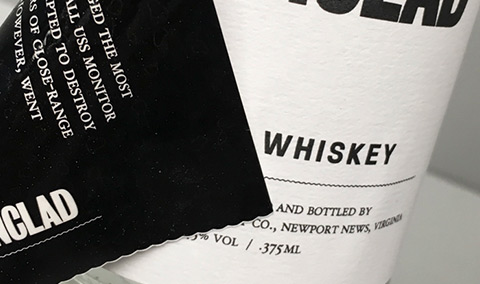 Peel and reseal label peeling back from a whiskey bottle
