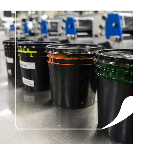Four buckets of custom colored inks for custom labels 