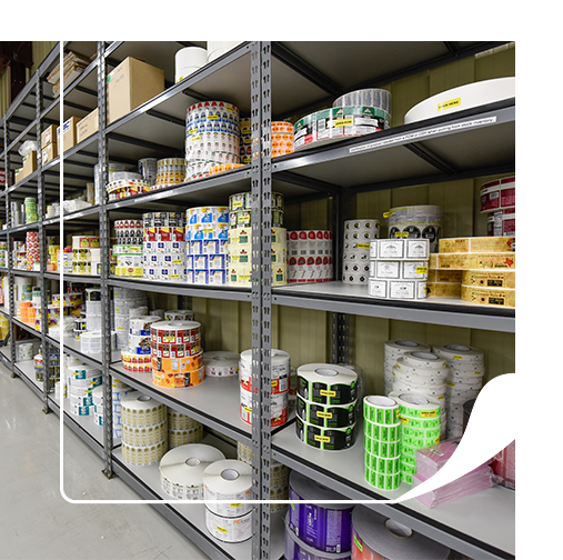 Rolls of custom labels stacked on a shelf