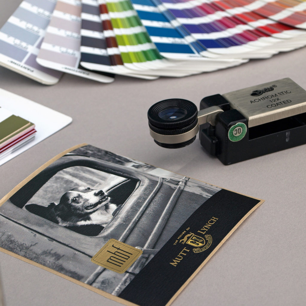 Magnifying glass, label and color samples for a press proof.