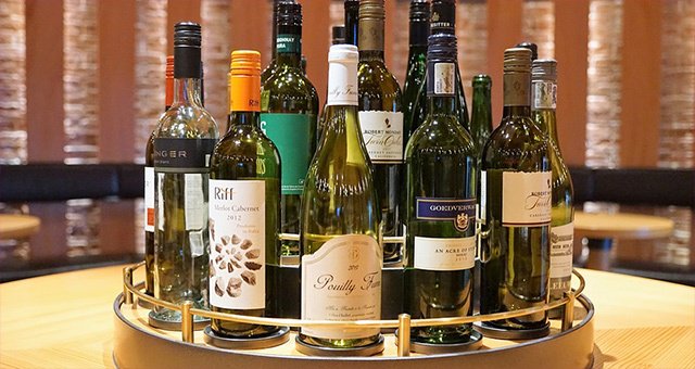 Wine bottles displayed on a revolving stand. 